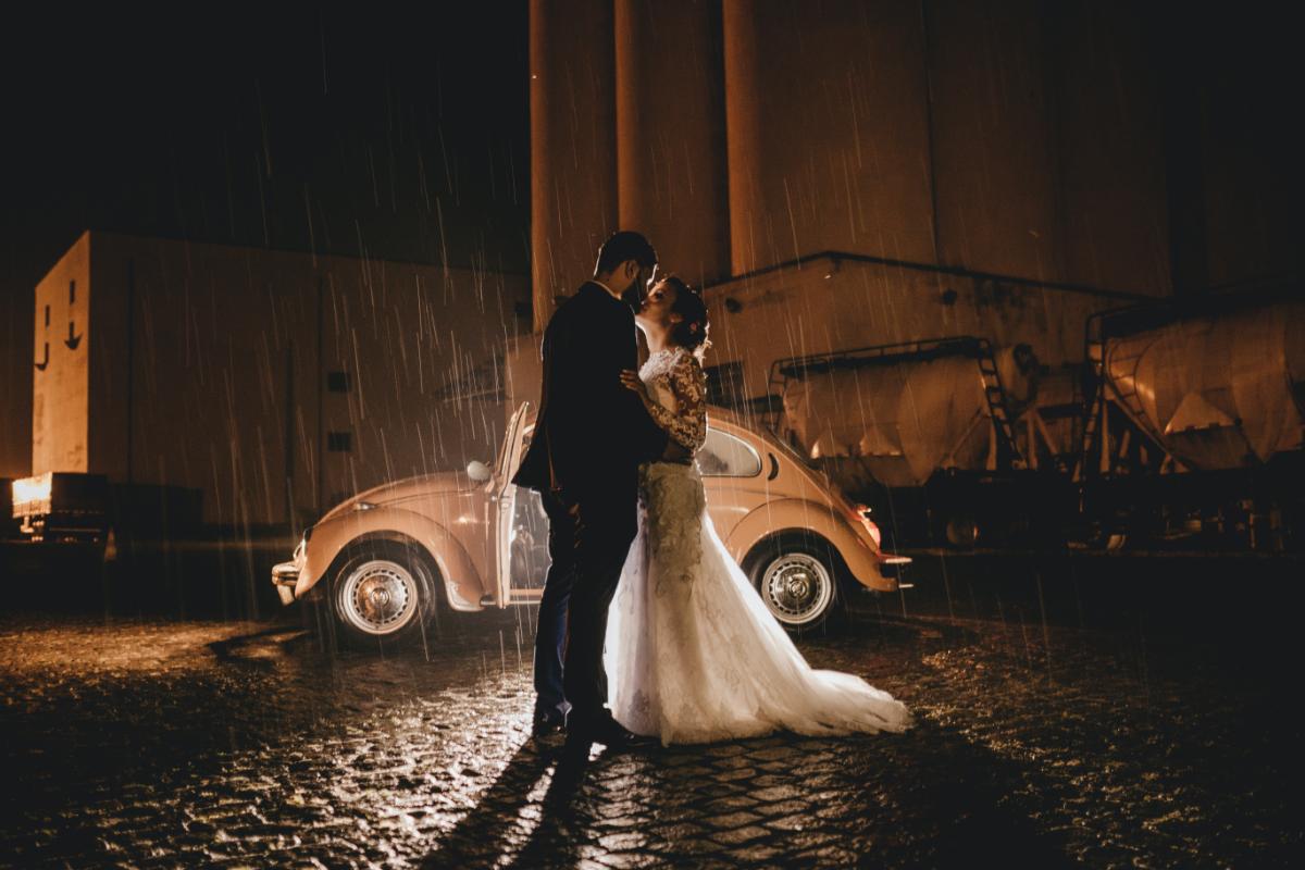Rain-on-wedding-day-couple-kissing-rain-car-building-1.jpg