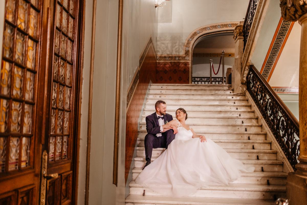 Rose gold wedding theme - band groom on castle stairs