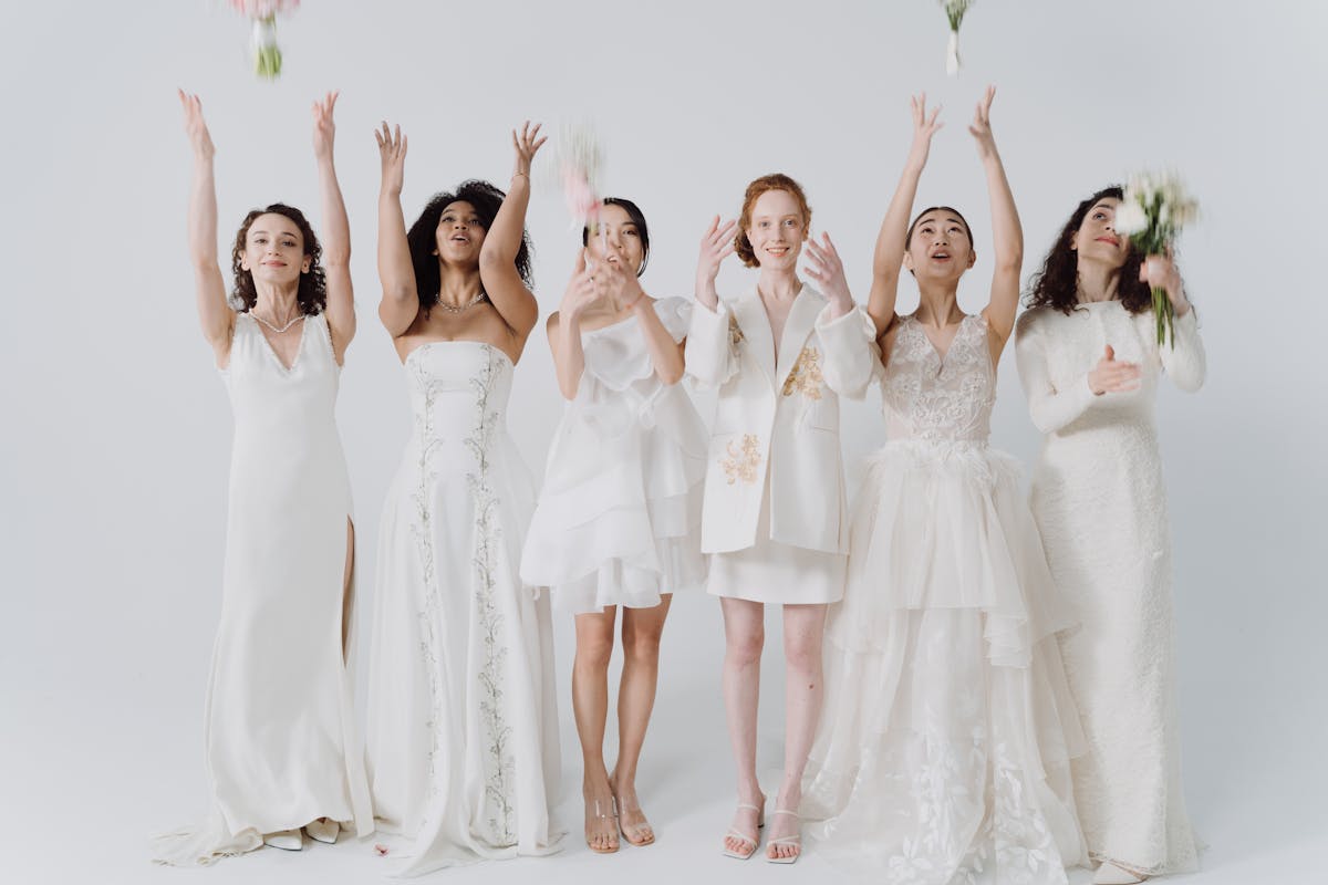 Why should you consider an elegant all white wedding decor_bride and bridesmaids dressed in white