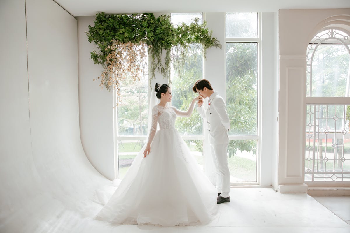 Why should you consider an elegant all white wedding decor_bride and groom with off white attire
