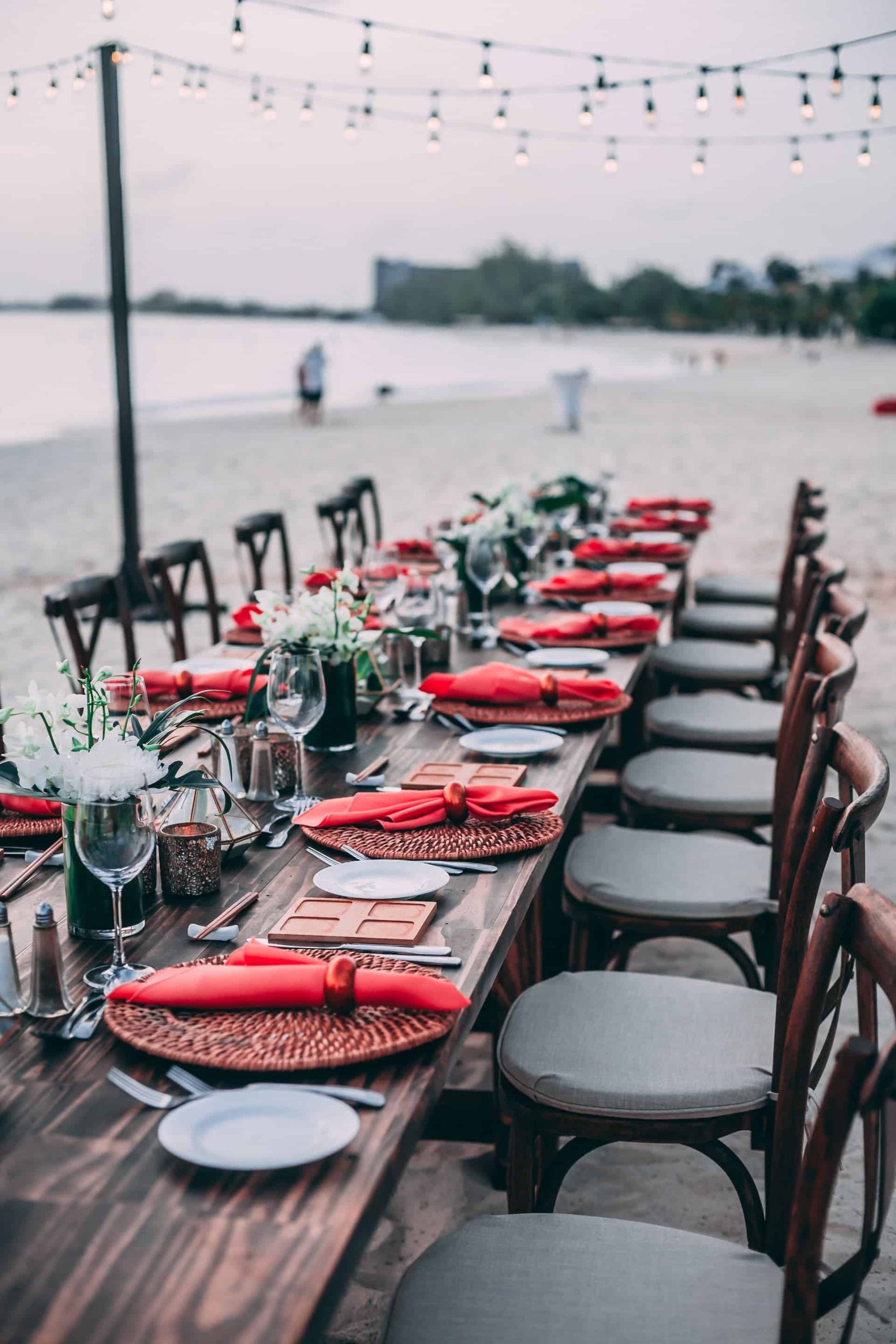 Sunset-wedding-decor-and-setup-chairs-wine-beach-lights-1-scaled